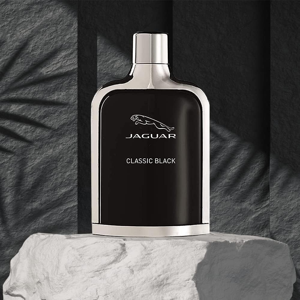 Jaguar Classic Black perfume bottle on a textured surface with a dark background