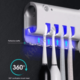 Ultraviolet toothbrush sterilizer with four toothbrushes inside, on a dark background.
