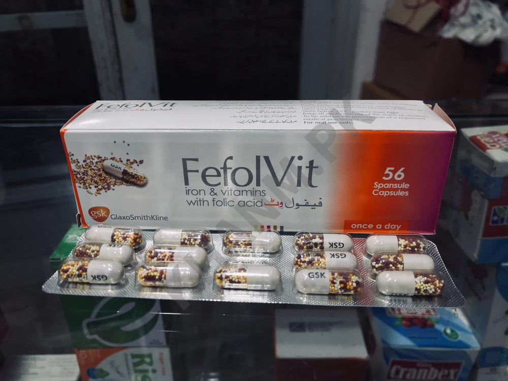 FefolVit iron & vitamins with folic acid packaging and capsules on a reflective surface.