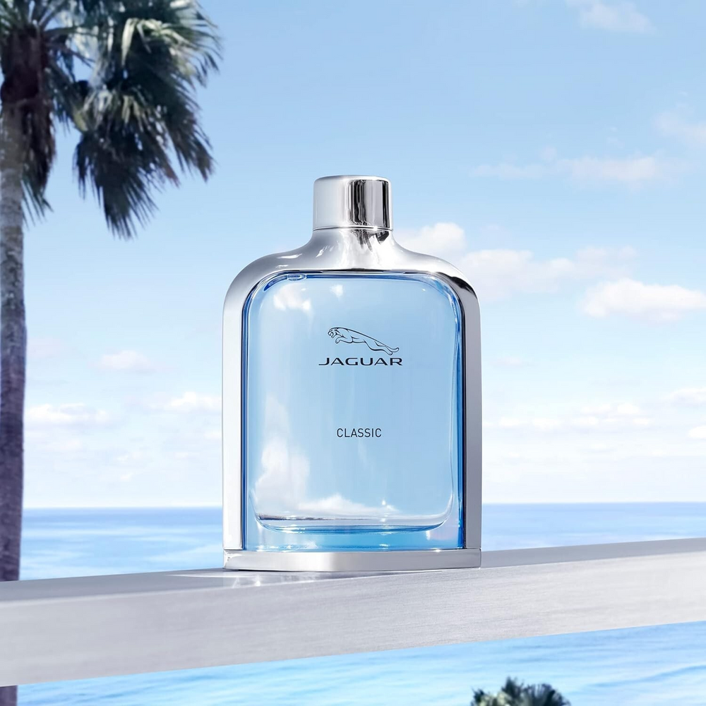 Jaguar Classic perfume bottle with a scenic background of palm trees and ocean.
