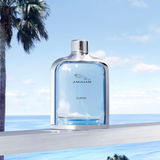 Jaguar Classic perfume bottle with a scenic background of palm trees and ocean.