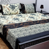 Decorative bedspread with floral and zebra pattern on a bed in a room.