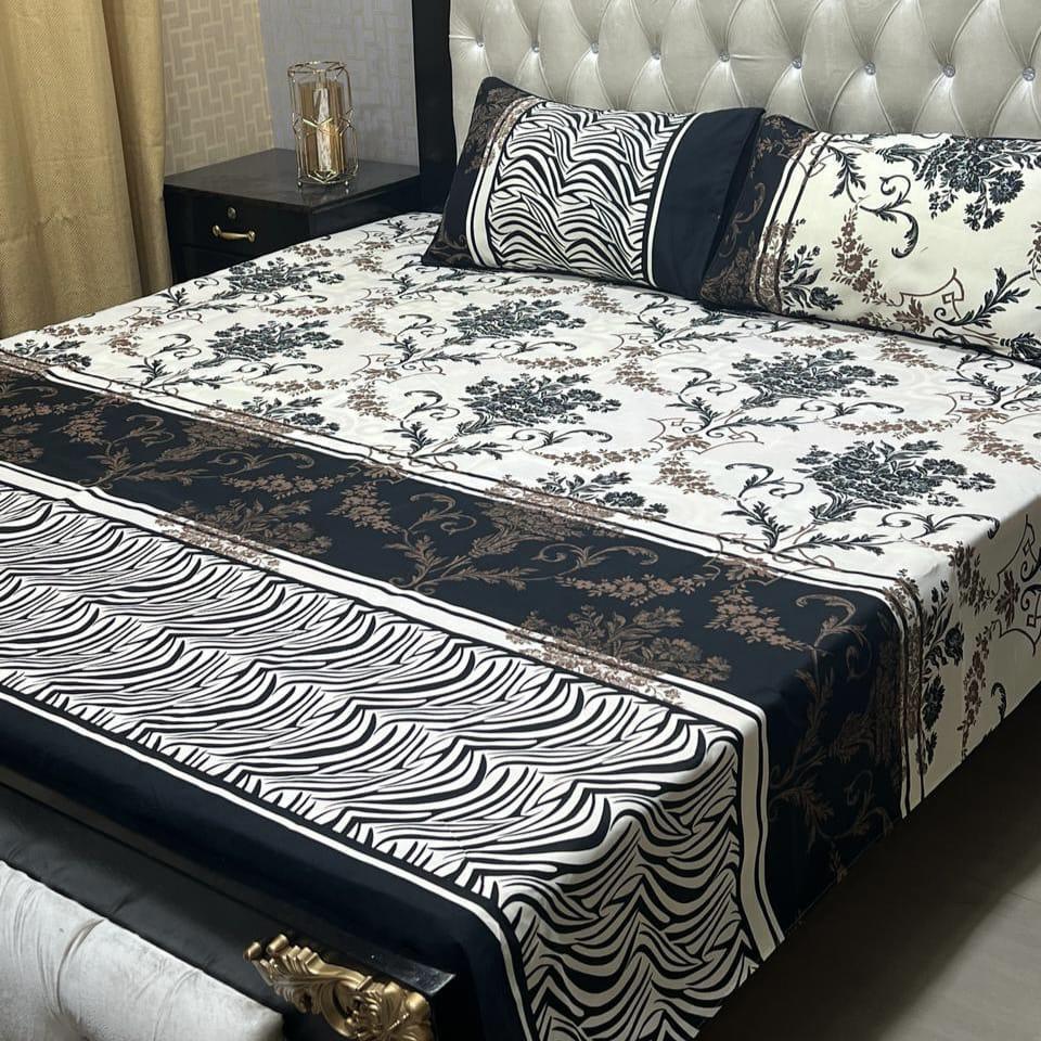 Bed with floral and zebra print bedding in a bedroom setting.