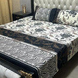 Bed with floral and zebra print bedding in a bedroom setting.