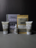 The Ordinary skincare products including face and hand cream, serum, and packaging on a dark background