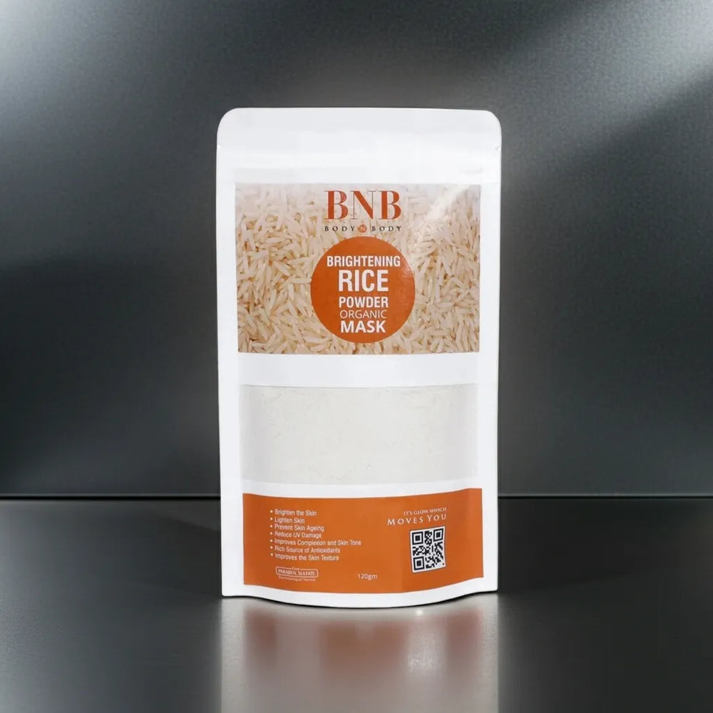 BNB Brightening Rice Powder Mask packaging on a reflective black surface with a dark background