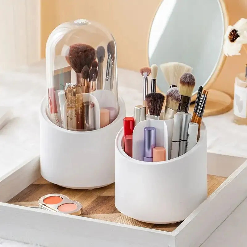 White cylindrical makeup organizers with brushes and lip products on a vanity.