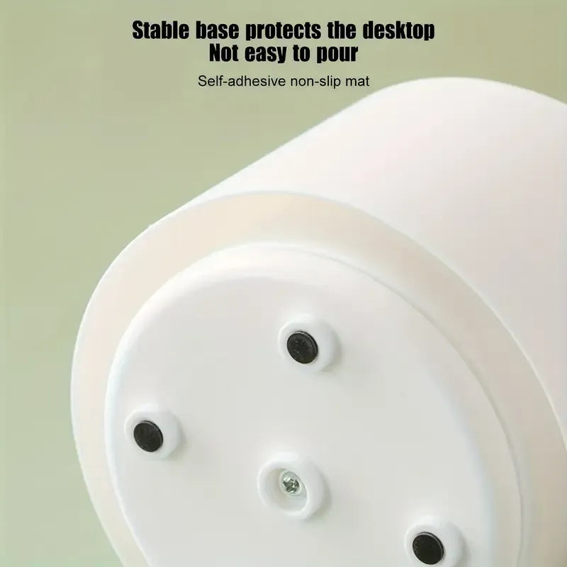 White circular object with adhesive pads on a light green background