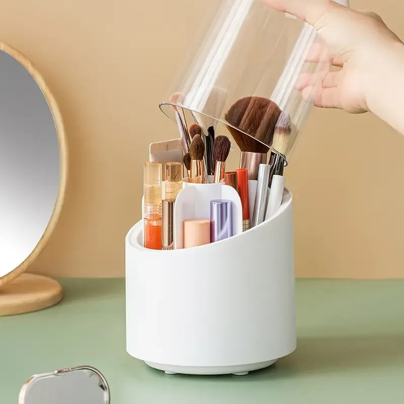 White makeup brush holder with various brushes and containers on a green surface.